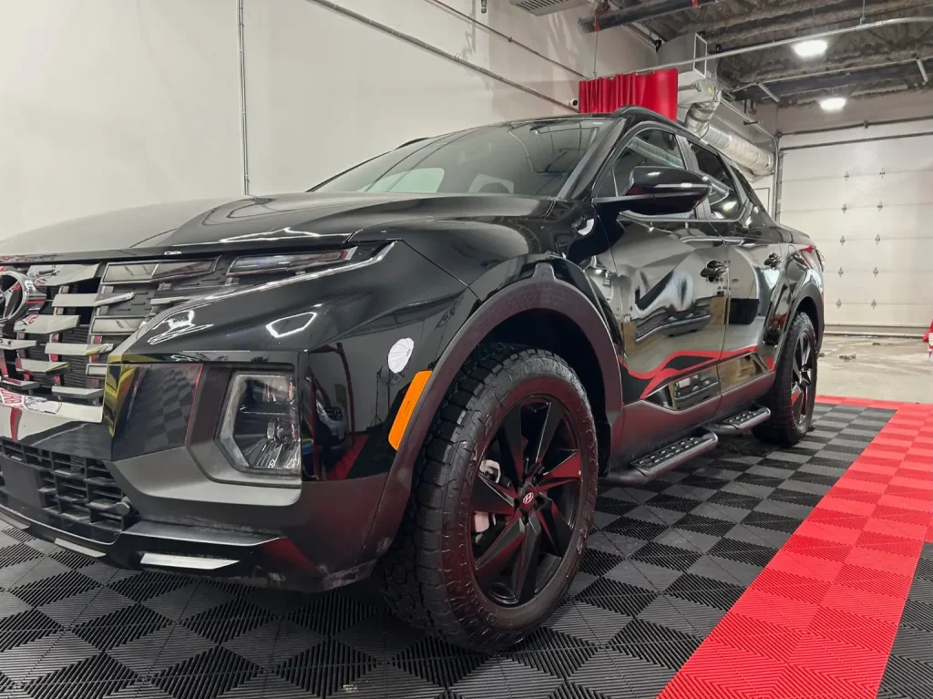 Complete detailing calgary technician polishing vehicle exterior at Stance Bros